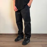 Pantalón jean de corte baggy, color negro gastado, con diseño holgado y bolsillos laterales.