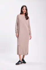 Vestido largo color beige de tejido de punto, con mangas largas y corte recto.