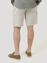 Short de lino orgánico color beige, con ajuste de cordón en la cintura, bolsillos laterales y traseros, y corte relajado.
