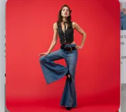 Jean de tiro alto con corte oxford, confeccionado en denim azul clásico. Presenta un diseño de pierna ancha y acampanada con costuras verticales que estilizan la silueta.