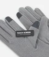 Guantes negros de poliéster y poliuretano, con detalle touch screen en uno de los dedos.