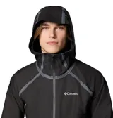 Campera impermeable Columbia modelo Reign No Shine Jkt Outdry, de color negro con capucha ajustable y cierre frontal con cremallera. Presenta un acabado mate, costuras selladas visibles en contraste gris y tecnología OutDry Extreme para mayor protección contra la lluvia.