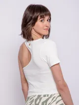 Top asimétrico blanco con una manga corta y un corte en el hombro.