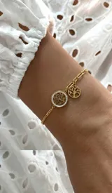 Pulsera de acero dorado con cadena combinada de eslabones y dijes colgantes del Árbol de la Vida, uno de ellos con fondo de nácar.