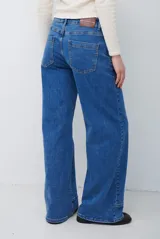 Jean de corte recto y tiro medio, color azul lavado, con costuras verticales decorativas en el frente y ruedo con dobladillo ancho.