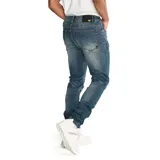 Jeans skinny para hombre, de corte ajustado y diseño de cinco bolsillos, con cierre de cremallera y botón metálico. Presenta un lavado azul medio con efecto desgastado.