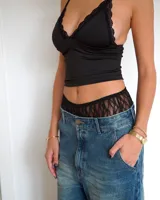 Culotte de encaje negro con diseño de red, de tiro medio y ajuste elástico en la cintura.