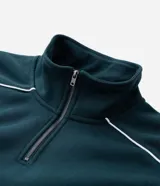 Buzo de cuello alto con medio cierre frontal, confeccionado en tejido de algodón con felpa. Presenta un corte boxy holgado, mangas largas con puños elásticos y una estampa gráfica circular en la espalda con la inscripción Off-Track Studio Company.