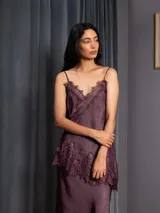 Top de raso asimétrico color morado, con detalles de puntilla en el escote y el bajo. Tiene breteles regulables y elástico en la espalda.