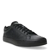 Championes Converse de corte bajo, color negro, confeccionados en cuero sintético. Presentan el logo de la marca grabado en el lateral, cierre con cordones al tono y suela de goma vulcanizada.