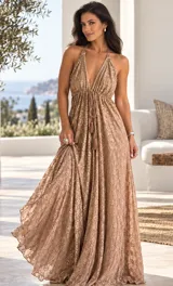Vestido largo rosado con escote en V halter, tirantes finos y falda fluida amplia. Presenta bordados artesanales a mano con detalles brillantes en toda la prenda y cordón frontal ajustable con borlas.