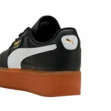 Championes urbanos Puma modelo Palermo Platform, color negro con franja lateral blanca y suela de plataforma color caramelo. Presenta detalles en dorado en la lengüeta y el lateral.