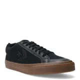 Championes Converse de estilo urbano, confeccionados en lona negra con detalles en cuero sintético. Presentan el logo de la marca en el lateral, puntera reforzada y suela de goma color caramelo (gum sole).
