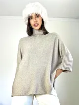 Poleron de punto color beige, con cuello alto y mangas tres cuartos con puños acanalados. Diseño holgado y oversized.