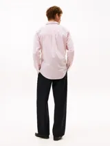 Camisa de manga larga Tommy Hilfiger de corte regular, confeccionada en popelín de algodón blanco con diseño de rayas verticales rojas. Cuenta con cuello clásico, cierre frontal de botones y el logo de la marca bordado en el pecho.