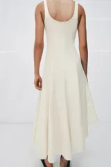 Vestido largo color blanco de algodón, con escote redondo, tirantes anchos y bajo asimétrico con godets.