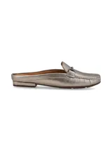 Mocasín tipo mule destalonado de cuero metalizado color peltre, con detalle de hebilla metálica ornamental en el empeine y suela de goma.
