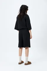 Bermuda marrón de algodón y poliéster, corte relajado, tiro medio, cordón ajustable en la cintura y estampado con inspiración college.