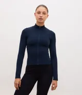 Campera deportiva Get Over de color azul marino, confeccionada en tejido seamless con textura acanalada. Presenta corte ajustado, cuello alto y cierre frontal completo por cremallera.
