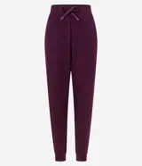 Pantalón tipo jogger de mujer, confeccionado en tejido modal con mezcla de poliéster y elastano. Presenta cintura elástica con lazo de ajuste, bolsillos laterales y puños elásticos en el ruedo.