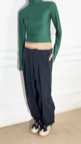 Polera verde esmeralda de lycra con cuello alto y mangas largas.