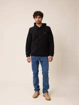 Canguro de polar azul con capucha y cordones ajustables. Presenta un bolsillo frontal tipo canguro y un pequeño logo bordado en el pecho.