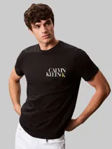 Remera de algodón negro con cuello redondo y mangas cortas. Presenta un diseño gráfico con el logo de la marca estampado en el pecho en color blanco y amarillo.
