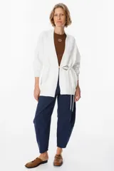 Saco abierto de punto color blanco, con diseño de textura cuadriculada en las mangas y corte holgado.