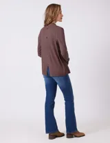 Cardigan de tejido liviano color marrón, con frente abierto, mangas largas entalladas con puños de rib y detalle de botones en la espalda.