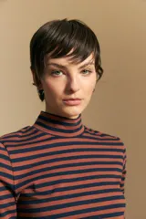 Polera de cuello alto y manga larga, confeccionada en tejido elástico con diseño de rayas horizontales en tonos azul marino y terracota.