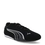 Championes Puma modelo Catch Sd, color negro con detalles en blanco. Diseño de perfil bajo con exterior de gamuza, cierre de cordones y suela de goma.