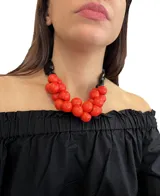 Collar corto de cuentas de resina rojas y negras, con cierre de mosquetón y cadena para regular el largo.