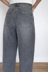 Jeans mom fit color gris, de tiro alto, con bolsillos delanteros y traseros. Confeccionado en algodón, lyocell y elastano.