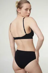 Soutien tipo bralette de microfibra sin costuras, con diseño de doble bretel regulable y detalle fruncido en el centro del escote. Cuenta con cierre de broche doble en la espalda con tres niveles de ajuste.
