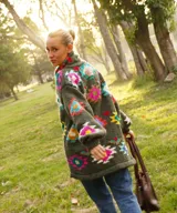 Saco tejido a mano de color verde militar, con cuello alto, mangas largas y diseño geométrico multicolor.