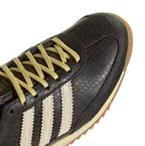 Championes Adidas SL 72 OG W con diseño de piel de serpiente en tonos marrones, franjas laterales blancas en zigzag y suela de goma dentada color caramelo.