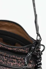 Cartera tipo bandolera con diseño acolchado y estampado animal print. Cuenta con múltiples compartimentos con cierre, correa ajustable con logo y detalle de cadena metálica decorativa y dije colgante con la palabra Lucky.