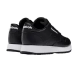 Championes Reebok de cuero negro con suela ondulada blanca.