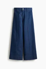 Jean ancho tobillero de tiro alto en denim de algodón con ligero stretch, con pliegues frontales pespunteados y corte holgado.