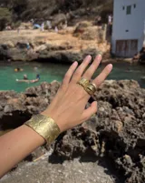 Anillo de diseño enlazado con textura irregular, realizado a mano en bronce. Presenta un diseño abierto que permite regular su tamaño con suavidad.