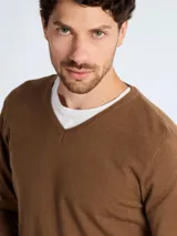 Sweater de punto con cuello en V, manga larga y puños acanalados, de corte clásico.