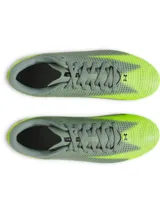 Championes de fútbol Under Armour modelo Shadow Select 3 FG, con diseño en tonos gris y amarillo neón. Presentan una parte superior de piel sintética suave, cierre con cordones, plantilla de EVA para mayor comodidad y suela de TPU con tacos cónicos optimizados para superficies naturales firmes.
