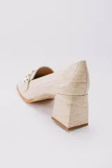 Zapato clásico color beige con textura croco, taco cuadrado y punta cuadrada.