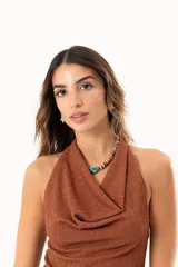 Top sin mangas color marrón con cuello volcado, confeccionado en tela de punto con textura sutil.