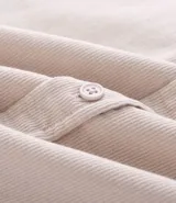 Camisa de hombre confeccionada en terciopelo de algodón, con cuello clásico, cierre frontal de botones y dos bolsillos con solapa en el pecho. Presenta un corte regular y mangas largas con puños abotonados.