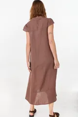 Vestido midi color azul de lino italiano, con diseño camisero, cuello camisero, mangas cortas abullonadas, cierre frontal con botones y bolsillos laterales.