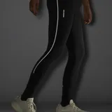 Calzas deportivas negras con bolsillos de almacenamiento y detalles reflectantes en las piernas, de diseño ceñido y elástico.