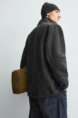 Chaqueta de corte relajado confeccionada en tejido de mezcla de algodón y lyocell con efecto lavado. Presenta cuello solapa, manga larga, cierre frontal con botonadura oculta por solapa y cuatro bolsillos frontales con solapa.