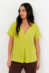 Blusa de lino color verde lima, con escote en V, mangas cortas y detalle de pliegue frontal.
