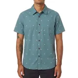 Camisa Katin modelo Balance de manga corta, color verde con estampado de pequeños cuadrados blancos. Cuenta con cuello clásico, cierre frontal con botones oscuros y un bolsillo aplicado en el pecho.